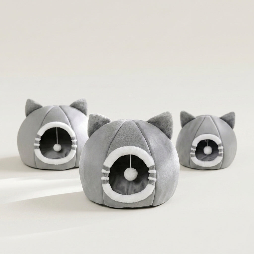 Three gray cat-shaped plush pet houses with cat-ear tops and circular openings, arranged on a clean white studio background. The medium sized bed is in the foreground.