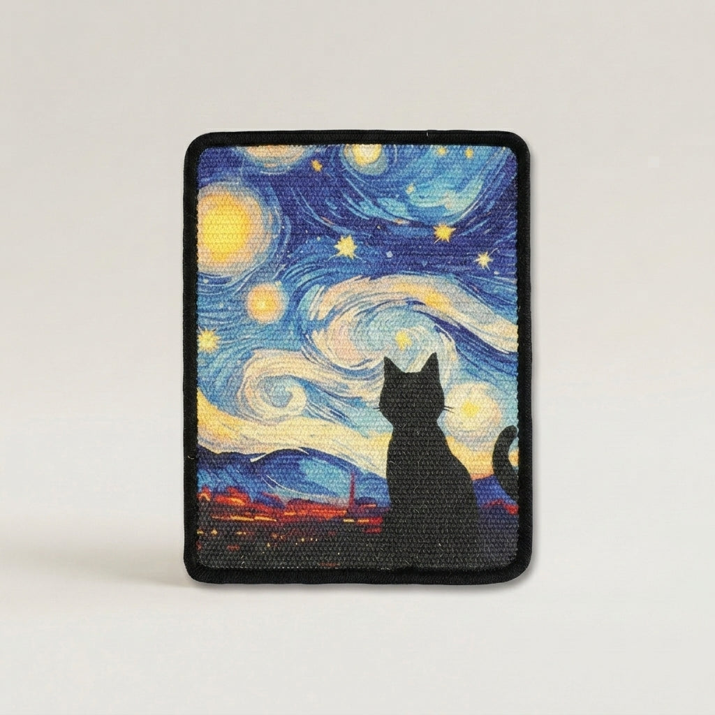 A cat scratch mat with rounded corners, featuring a black cat silhouette in front of a swirling blue, yellow, and white night sky inspired by Van Gogh's Starry Night, finished with a black stitched border.