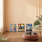 Three decorative pet art prints displayed on a beige wall in a styled room, with a gray cat sleeping on a round pink pet bed in the foreground.