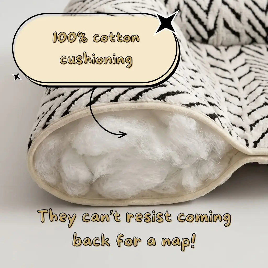 A close-up of a plush cushion with a black-and-white zebra-patterned fabric cover and thick white cotton filling, overlaid with text reading '100% cotton cushioning' and 'They can't resist coming back for a nap!'.