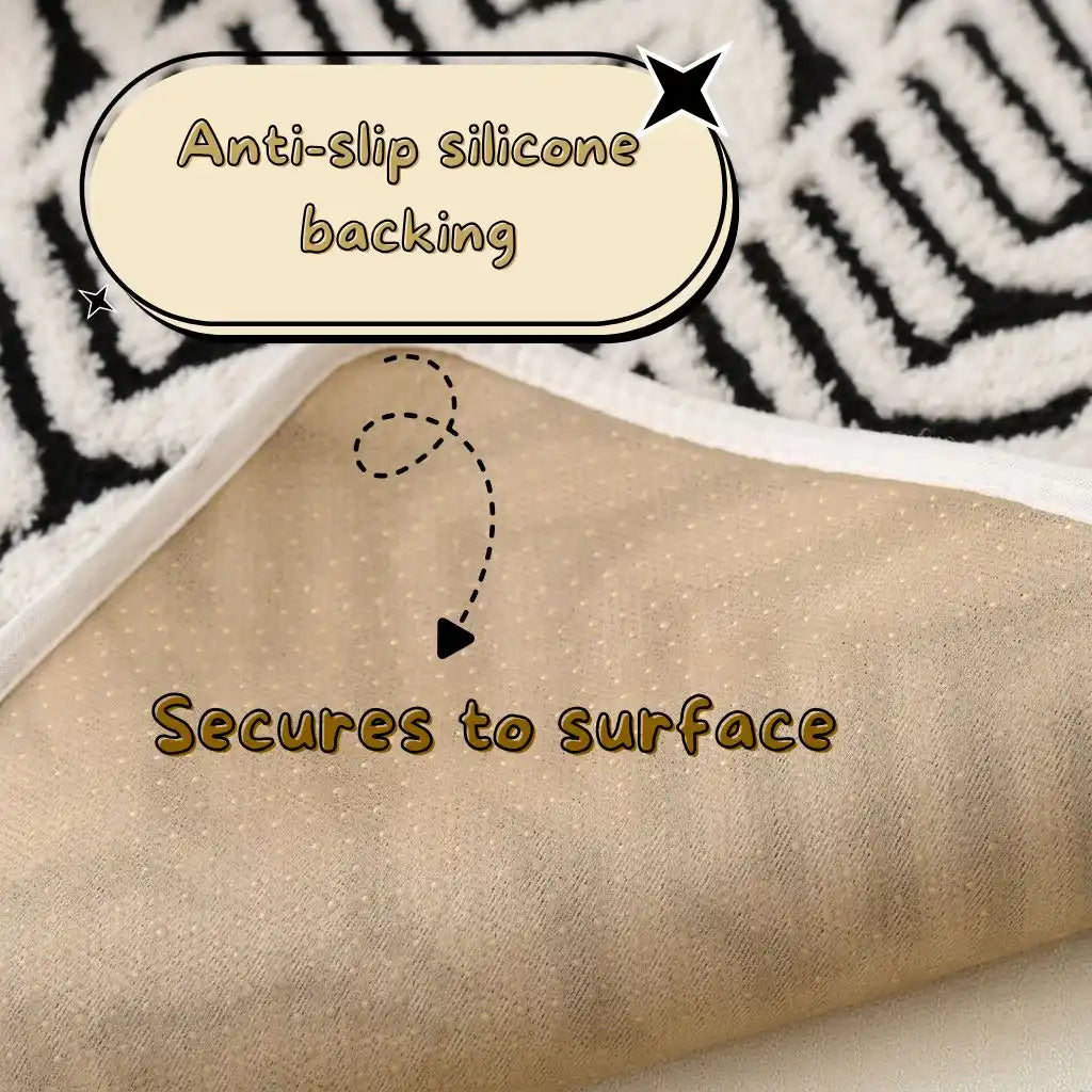 Close-up of a textured material folded over, with a black-and-white patterned surface underneath resembling a cat bed mat. Text overlays read 'Anti-slip silicone backing' and 'Secures to surface' with arrows pointing to the underside.