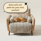 A cat bed mat with a patterned cushion and U-shaped side bolsters, shown on an armchair with an orange tabby cat resting on top. A speech bubble says 'Extra soft and plush for your cat's comfort!' against a plain light studio background.