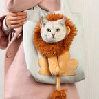 A person in a pink coat carries a light gray tote bag featuring a plush lion design with a real cat inside the lion's mane and paws visible at the front.