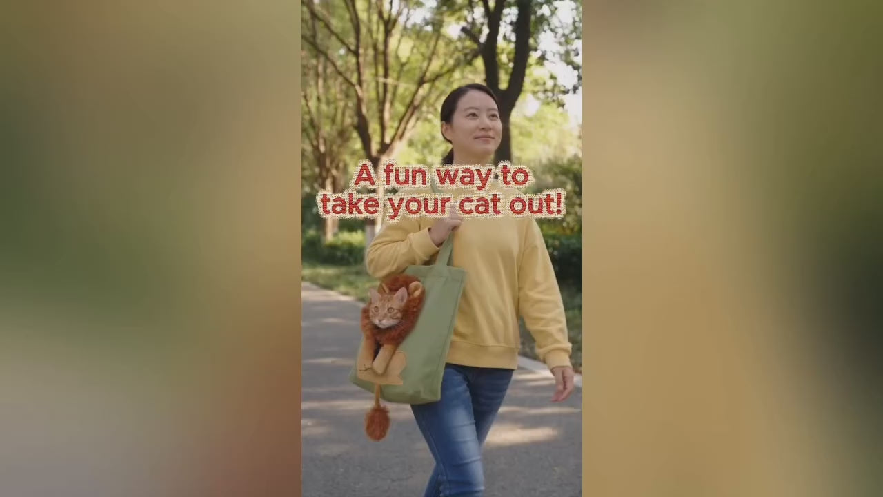 A woman wearing a yellow sweater is walking in a park, carrying a green tote bag with a cartoon lion decoration on it. The head of the lion is a hole where a cat's head is popping out.